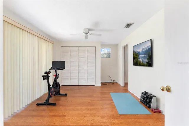 a view of an empty room with wooden floor