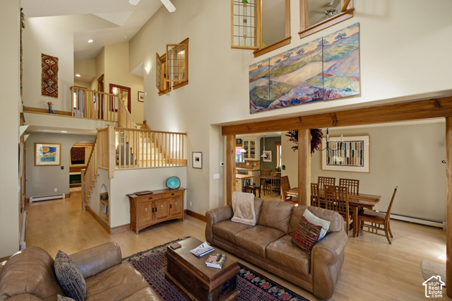 725 Canyon Road Smithfield, UT 84335 - Photo 17 of 100 Vaulted ceilings, wood-finish flooring, natural wood staircase with railing, wooden structural beams, and built-in shelving