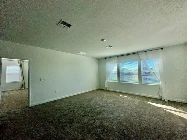 a view of a livingroom with a ceiling fan and window