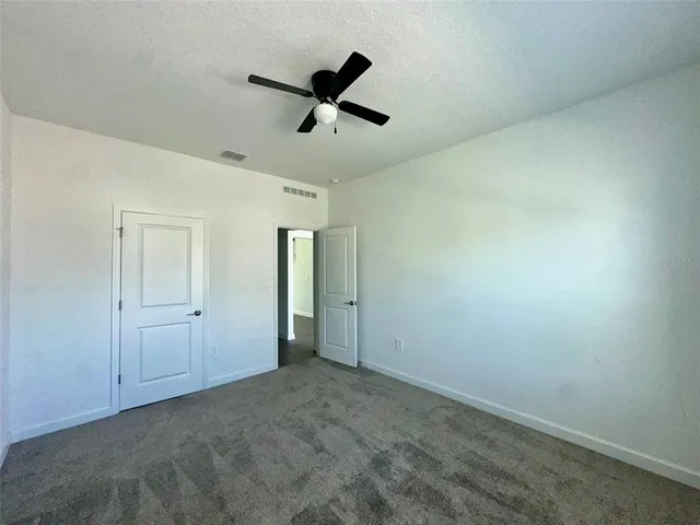 an empty room with a empty space and windows