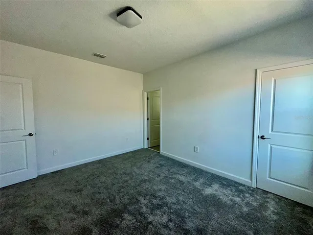 a bathroom with a granite countertop toilet a sink and a bathtub