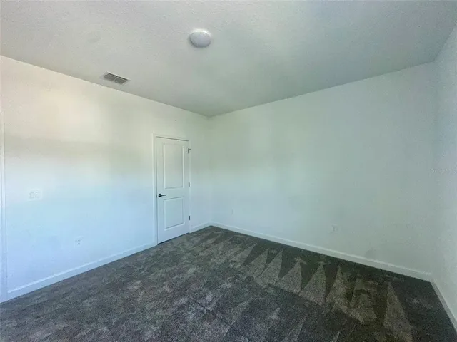 a bathroom with a granite countertop sink a toilet a mirror a bathtub and shower