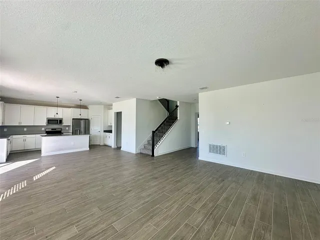 a view of a kitchen with a sink and a refrigerator