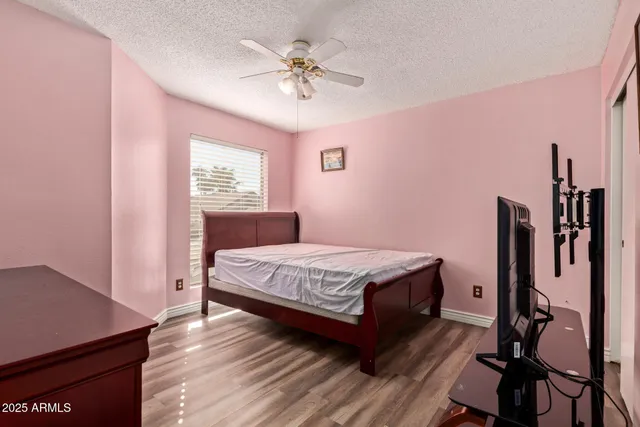 a bedroom with a bed dresser and a window