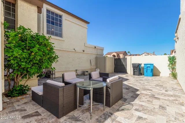 a view of a patio with couches and potted plants