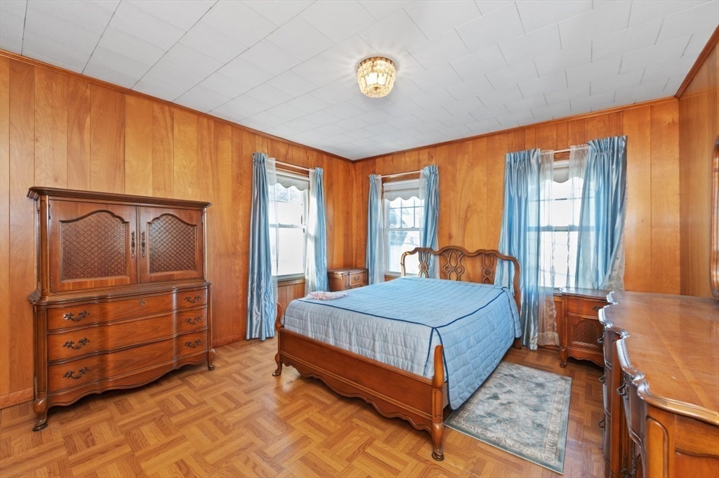 2 Perry Place Everett, MA 02149 - Photo 6 of 16 a room with a bed and a dresser