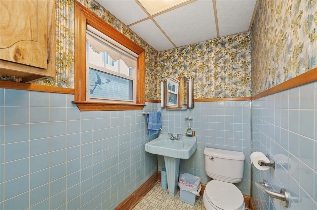 2 Perry Place Everett, MA 02149 - Photo 9 of 16 a bathroom with a sink a toilet and shower curtain