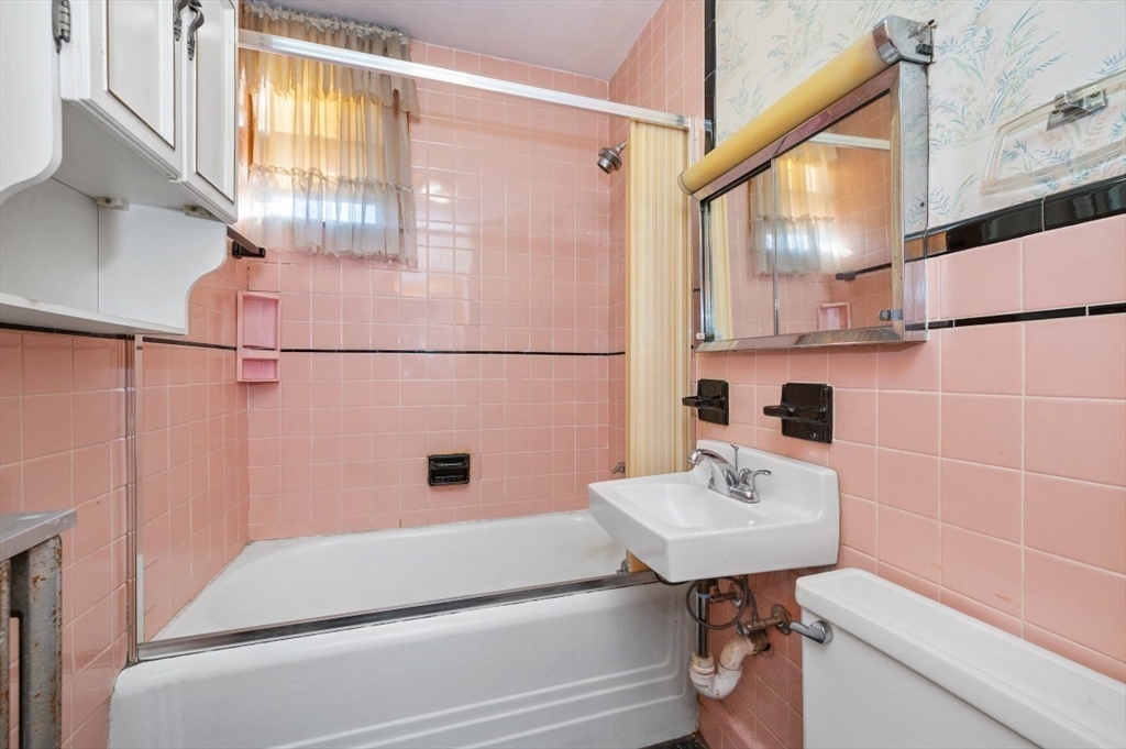 2 Perry Place Everett, MA 02149 - Photo 10 of 16 a bathroom with a sink and a mirror