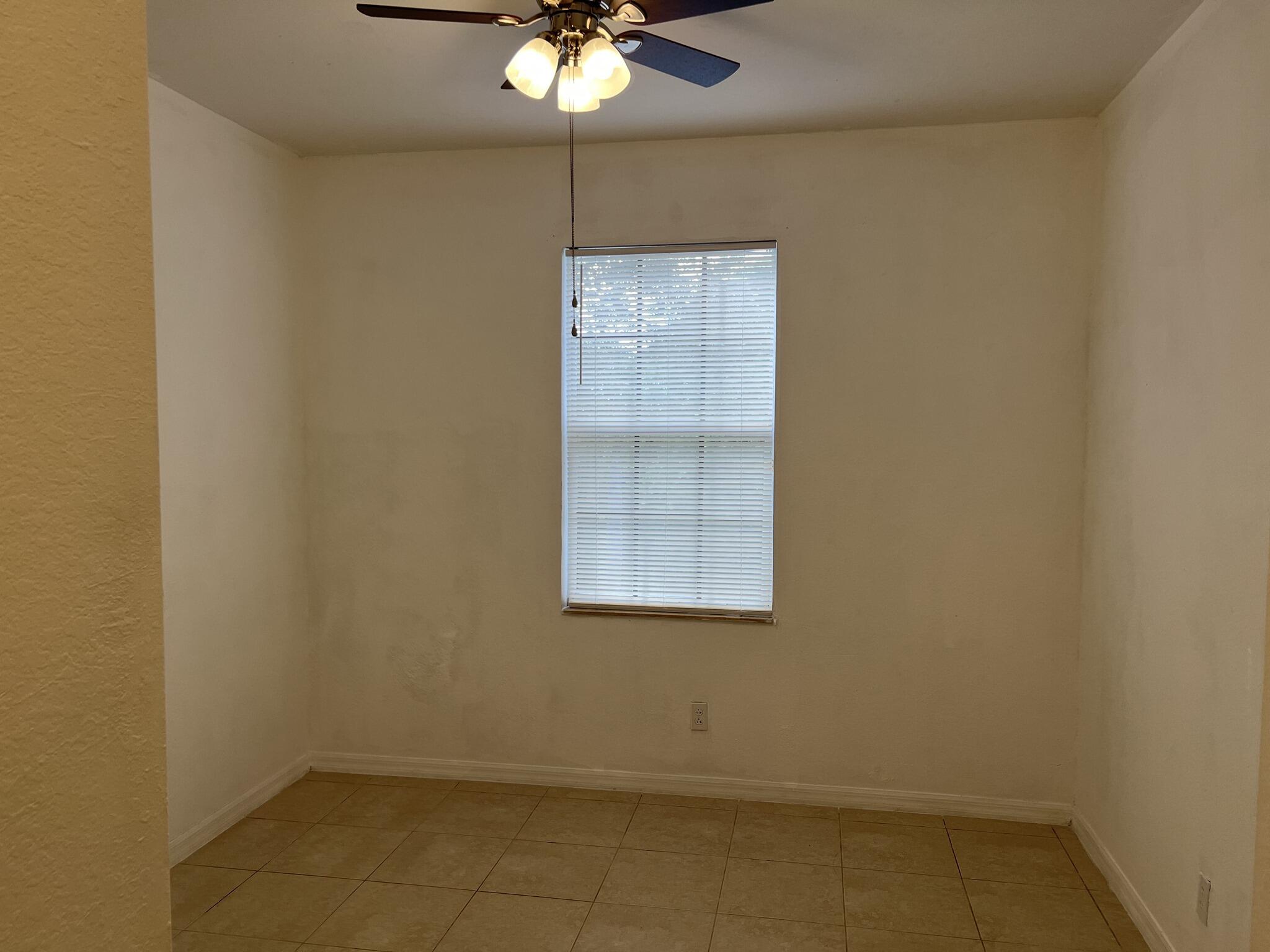 954 Pipers Cay Drive West Palm Beach, FL 33415 - Photo 5 of 6 an empty room with a window