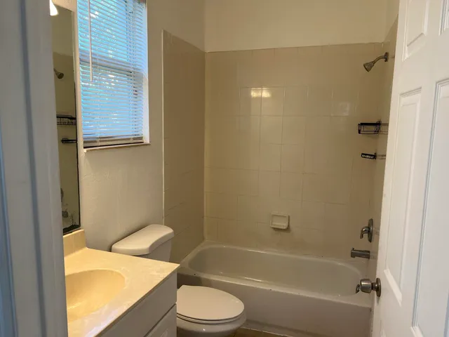 a bathroom with a sink a toilet and bathtub