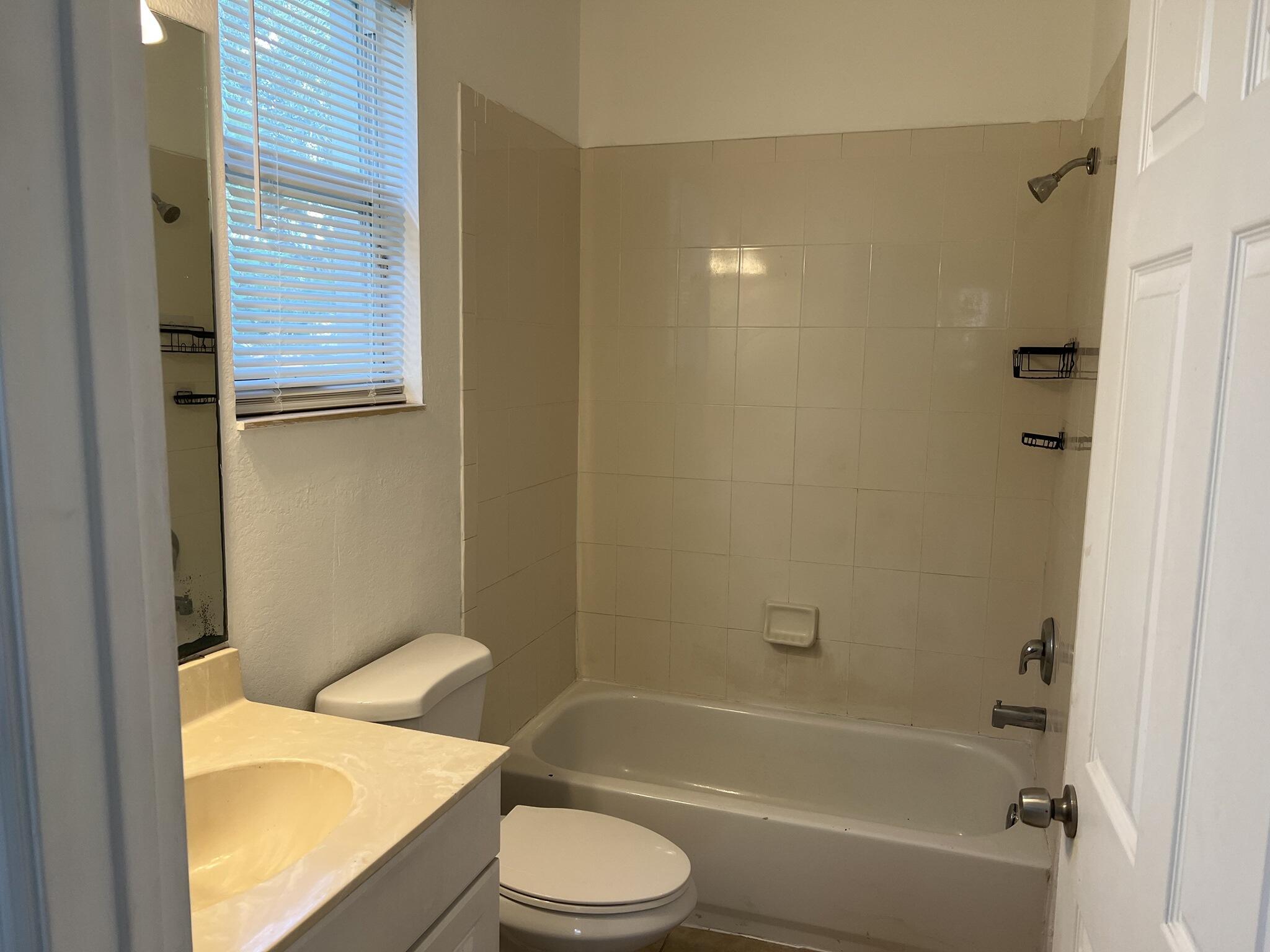 954 Pipers Cay Drive West Palm Beach, FL 33415 - Photo 6 of 6 a bathroom with a sink a toilet and bathtub