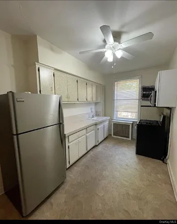 a white refrigerator freezer sitting in a kitchen