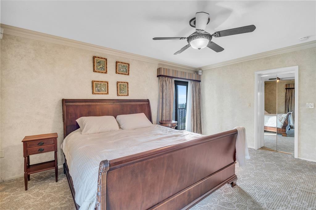 1920 Virginia Avenue, Unit 902 Fort Myers, FL 33901 - Photo 20 of 50 a bedroom with a large bed and a chandelier