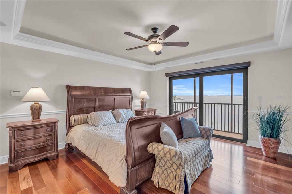 1920 Virginia Avenue, Unit 902 Fort Myers, FL 33901 - Photo 21 of 50 a bedroom with a bed and wooden floor