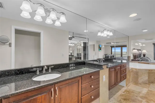 a view of a living room and kitchen with granite countertop a large window