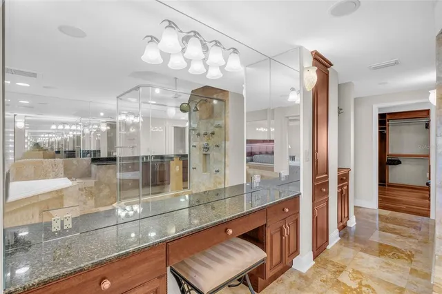 a bathroom with a granite countertop shower mirror and a sink