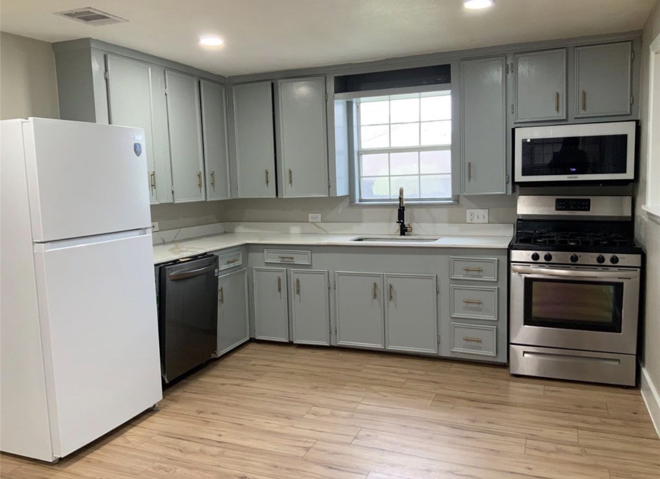 2415 Perry Street Baytown, TX 77521 - Photo 1 of 7 a kitchen with a sink stove and refrigerator