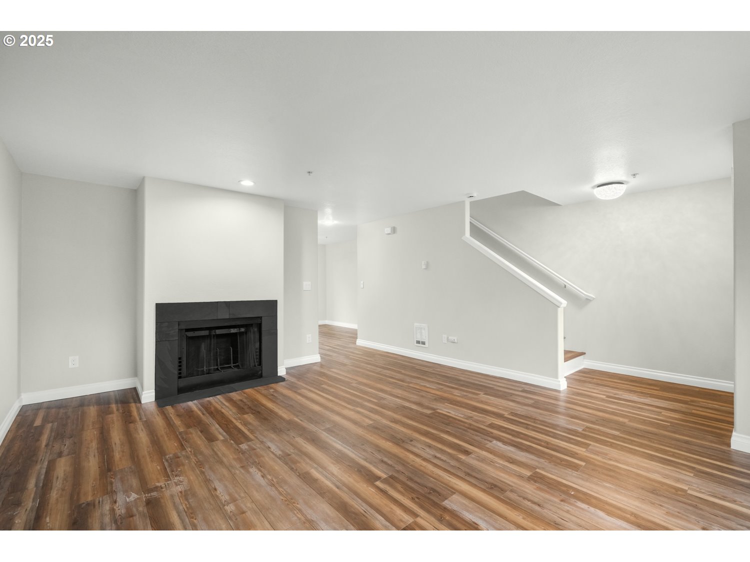 1244 Southwest 160th Avenue, Unit 104 Beaverton, OR 97006 - Photo 20 of 31 a view of empty room with wooden floor and fireplace