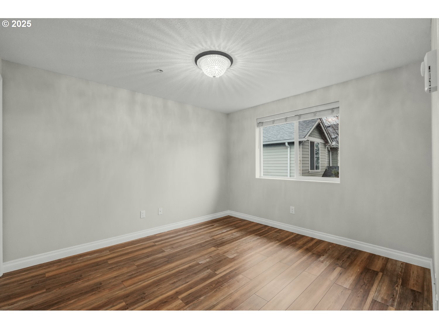1244 Southwest 160th Avenue, Unit 104 Beaverton, OR 97006 - Photo 26 of 31 a view of an empty room with wooden floor and a window