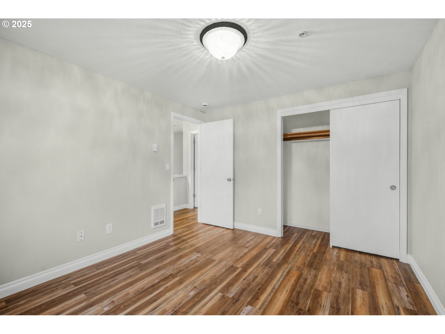 1244 Southwest 160th Avenue, Unit 104 Beaverton, OR 97006 - Photo 27 of 31 a view of an empty room with wooden floor and a window