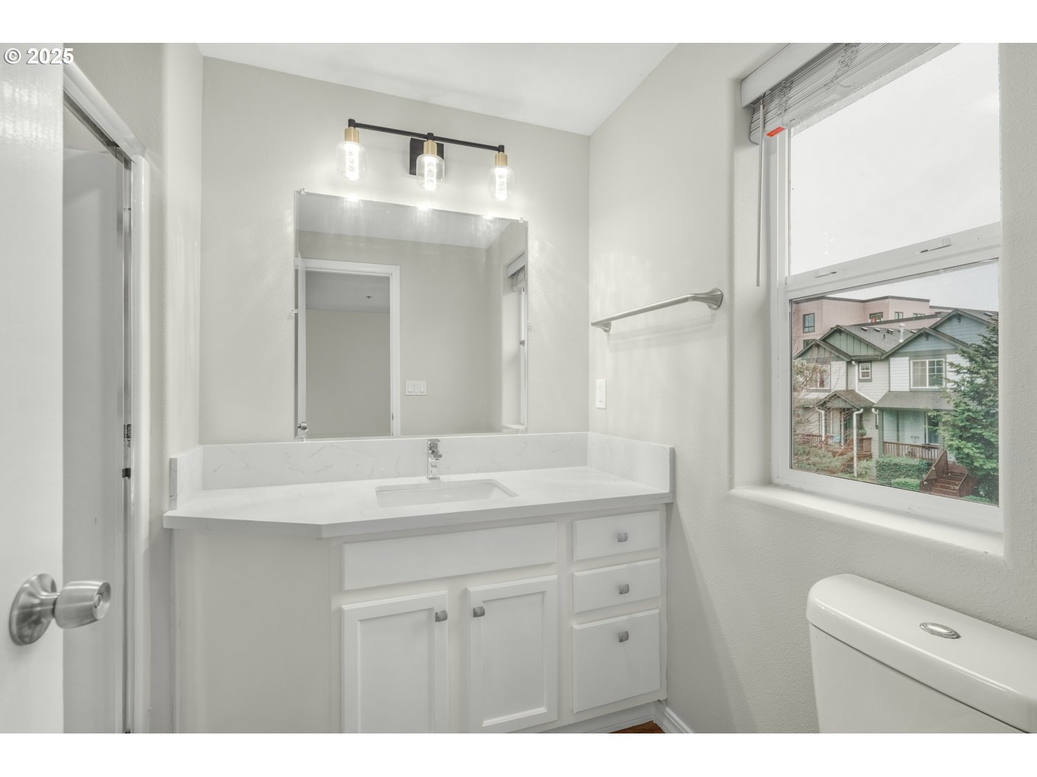 1244 Southwest 160th Avenue, Unit 104 Beaverton, OR 97006 - Photo 31 of 31 a bathroom with a double vanity sink and mirror with window