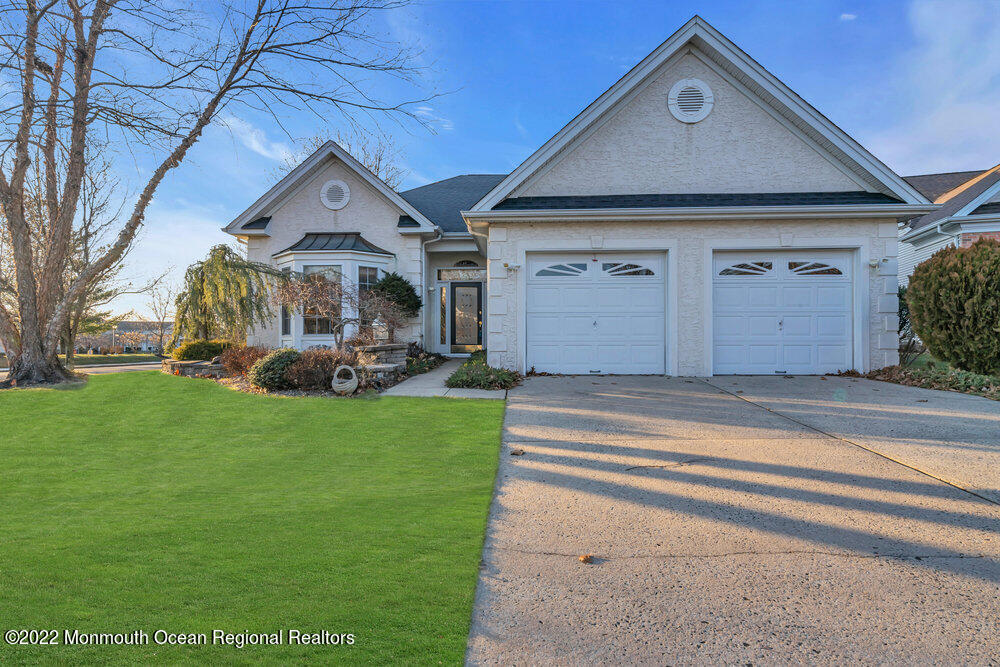 48 Winged Foot Road Jackson, NJ 08527 - Photo 3 of 69 a front view of a house with a garden and pathway