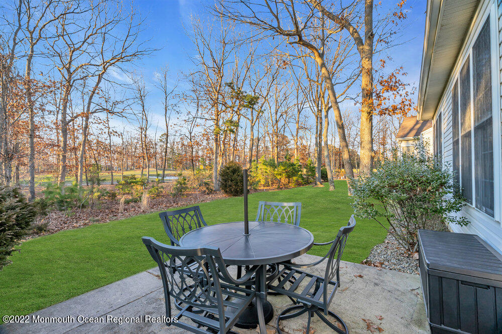 48 Winged Foot Road Jackson, NJ 08527 - Photo 45 of 69 a view of a chairs and table in backyard of the house