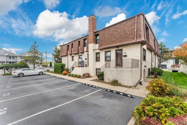 a view of a street with cars parked