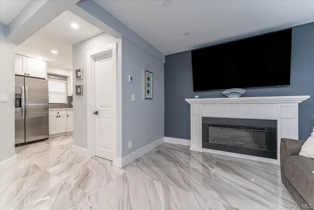 a view of a livingroom with a fireplace wooden floor and staircase