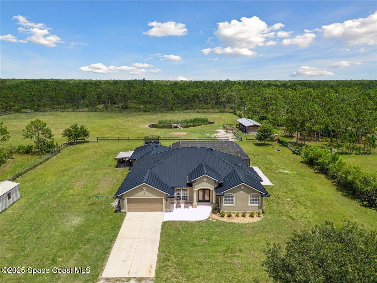 5005 Corey Road Grant Valkaria, FL 32950 - Photo 1 of 47 a view of a house with a yard and lake view
