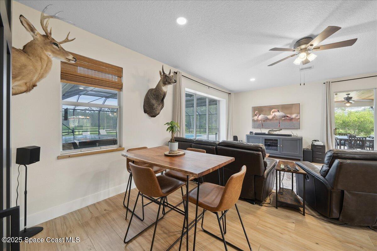 5005 Corey Road Grant Valkaria, FL 32950 - Photo 47 of 47 a view of a dining room with furniture window and wooden floor