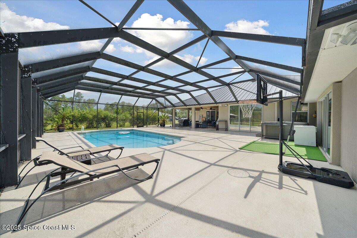 5005 Corey Road Grant Valkaria, FL 32950 - Photo 17 of 47 a roof deck with table and chairs and potted plants