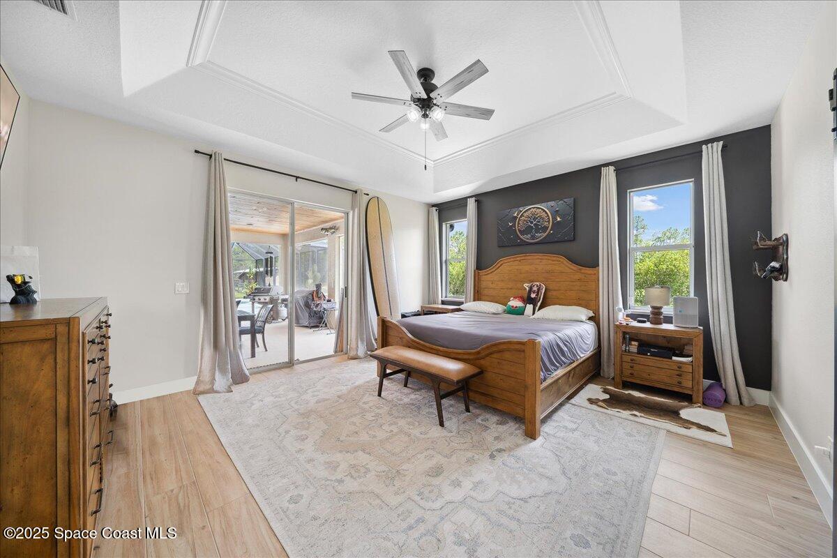 5005 Corey Road Grant Valkaria, FL 32950 - Photo 18 of 47 a bedroom with a bed and a large window