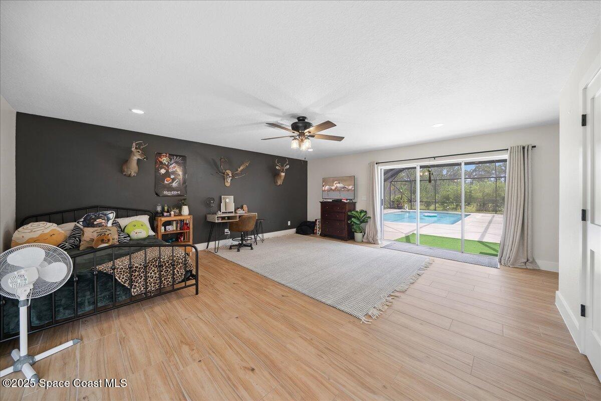 5005 Corey Road Grant Valkaria, FL 32950 - Photo 22 of 47 a living room with furniture and a large window