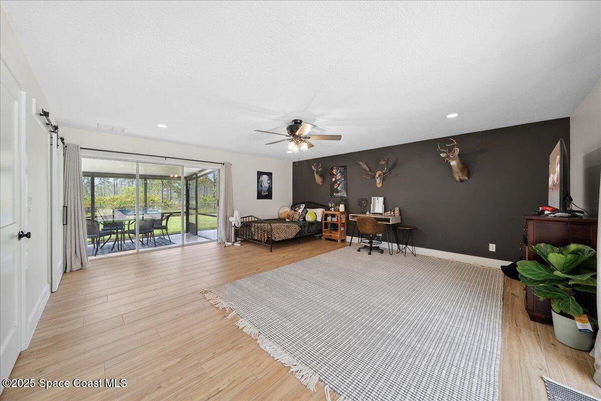 5005 Corey Road Grant Valkaria, FL 32950 - Photo 23 of 47 a very nice looking bedroom with a large window and furniture
