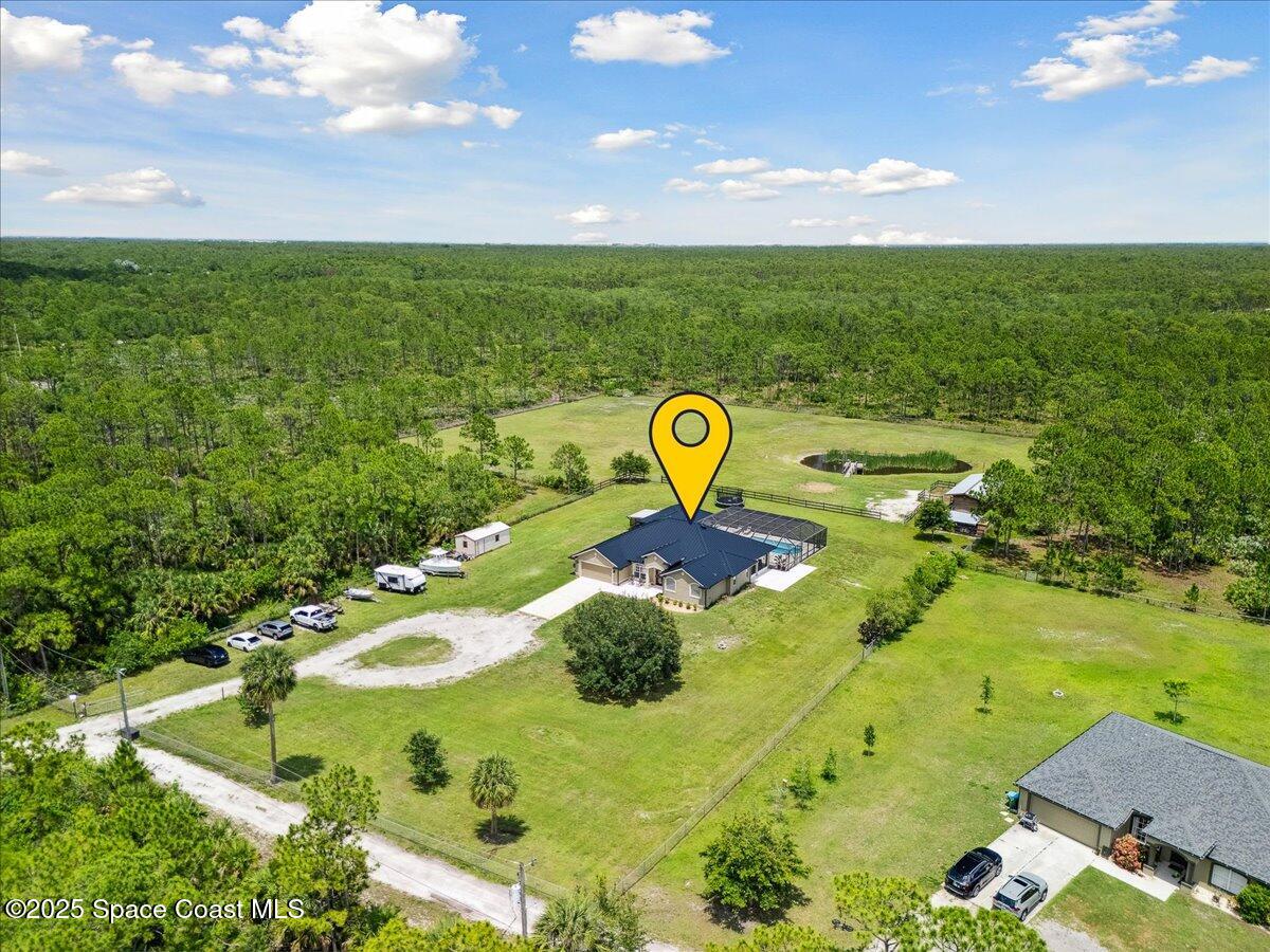 5005 Corey Road Grant Valkaria, FL 32950 - Photo 3 of 47 a view of a swimming pool with a yard