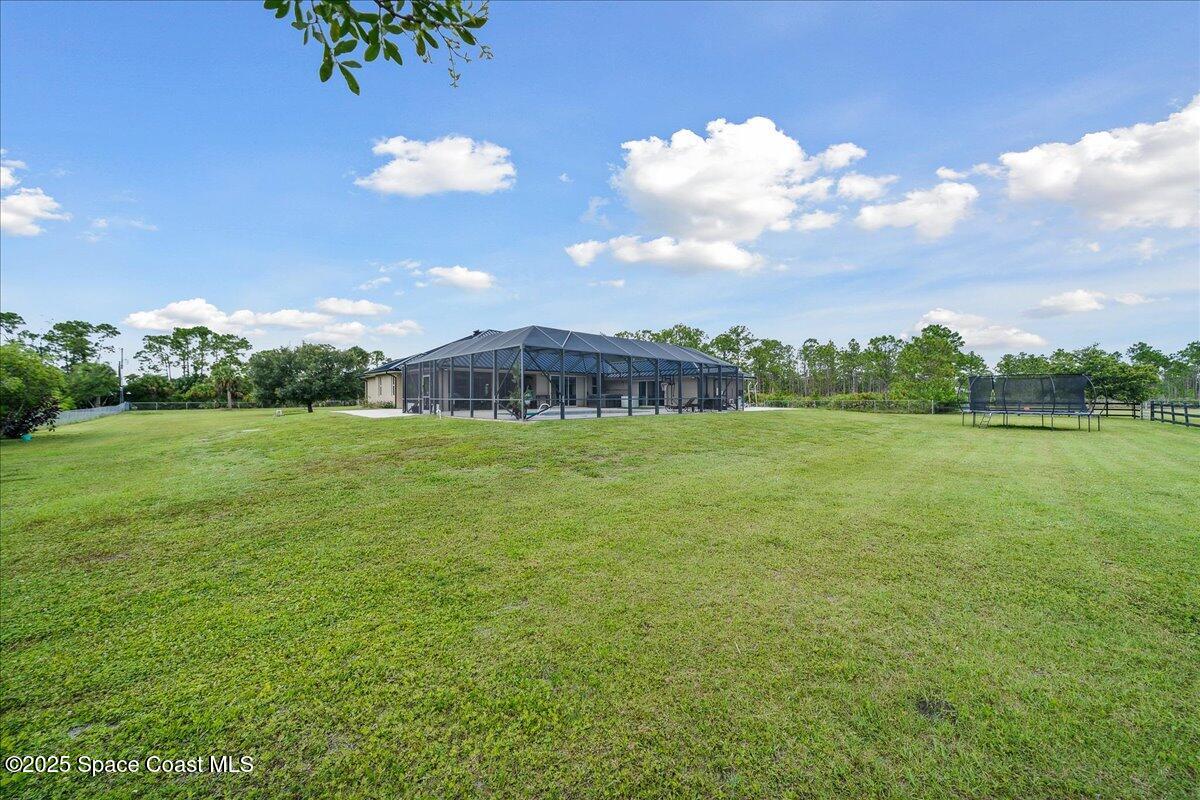5005 Corey Road Grant Valkaria, FL 32950 - Photo 32 of 47 a view of a garden with a building in the background