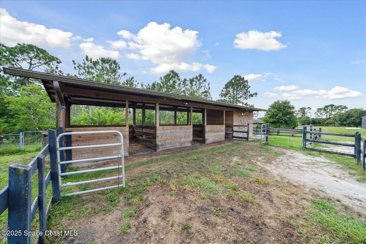 5005 Corey Road Grant Valkaria, FL 32950 - Photo 34 of 47 a view of a house with backyard and a backyard