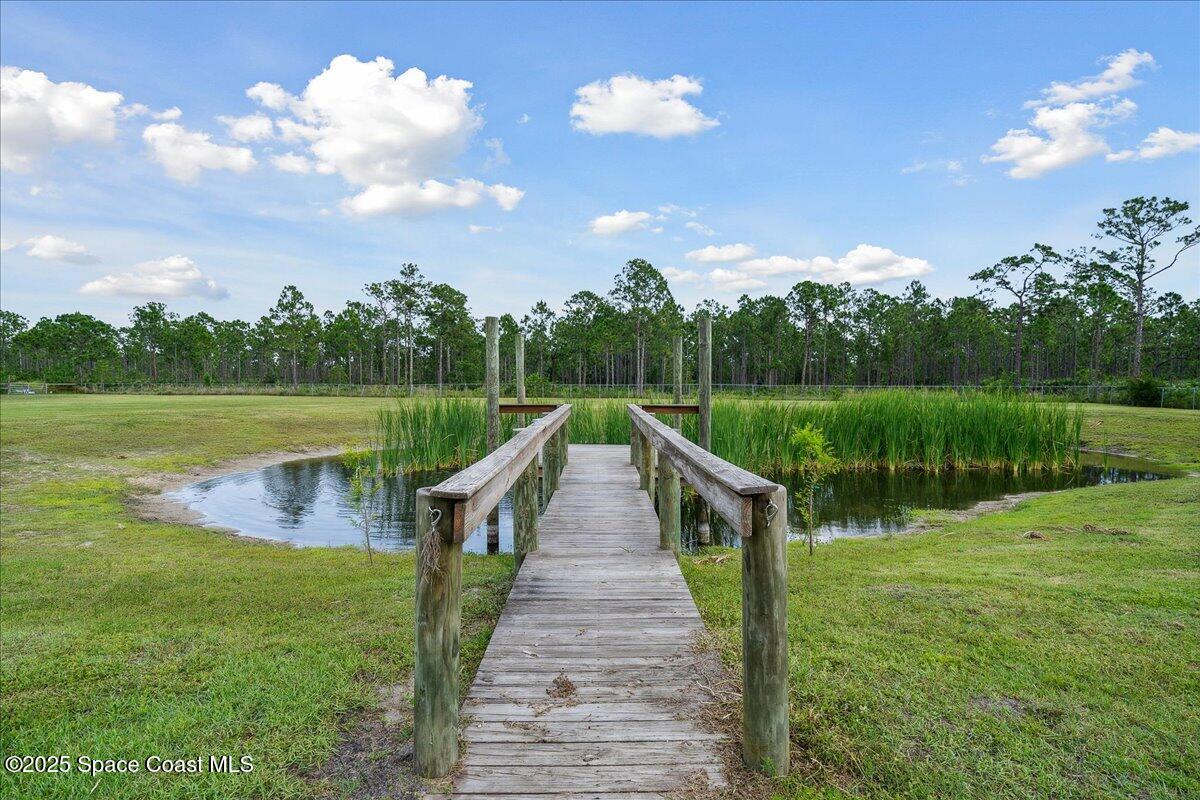 5005 Corey Road Grant Valkaria, FL 32950 - Photo 35 of 47 a view of a lake and a garden