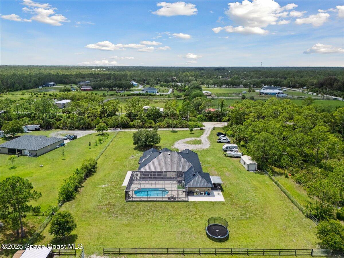 5005 Corey Road Grant Valkaria, FL 32950 - Photo 43 of 47 a view of a swimming pool with a yard