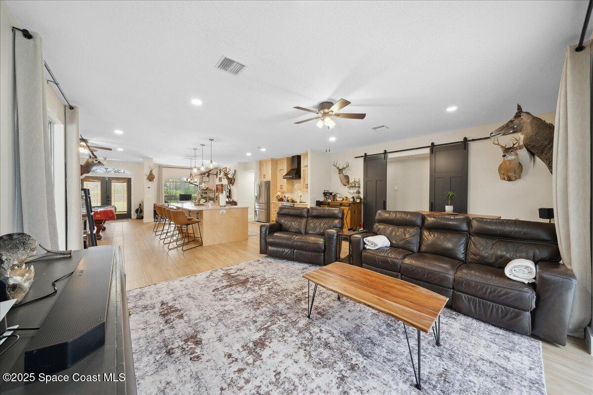 5005 Corey Road Grant Valkaria, FL 32950 - Photo 10 of 47 a living room with furniture and wooden floor