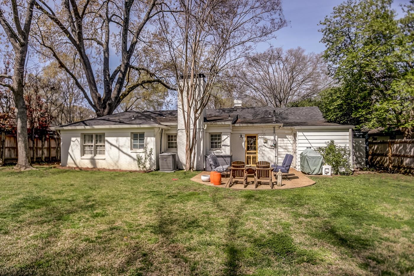 4697 Sequoia Road Memphis, TN 38117 - Photo 14 of 15 a view of a backyard with table and chairs and a large tree
