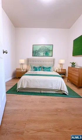 a spacious bedroom with a bed and a flat screen tv