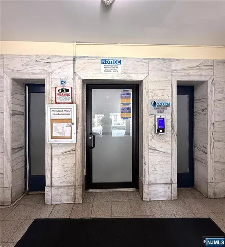 a lobby with a glass door shower and a mirror