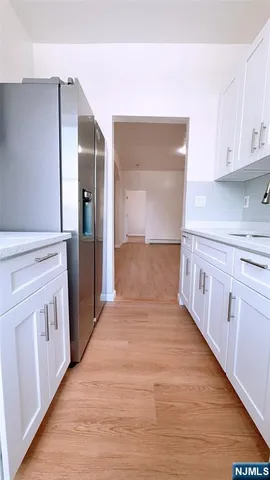 a kitchen with white cabinets
