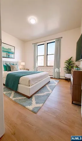 a spacious bedroom with a large bed and a large window