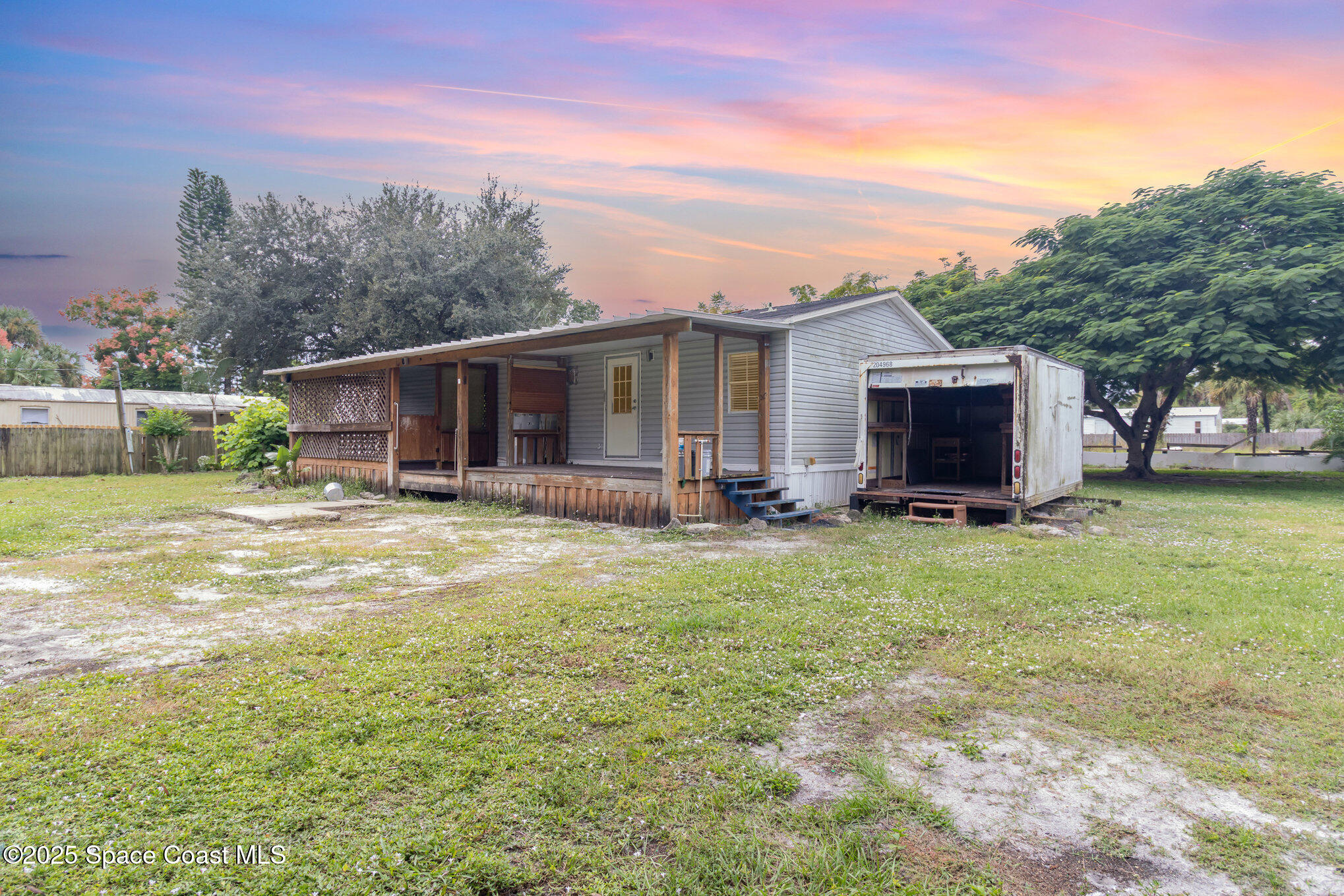 344 Robyn Street Cocoa, FL 32927 - Photo 20 of 21 a view of a backyard with a garden and trees