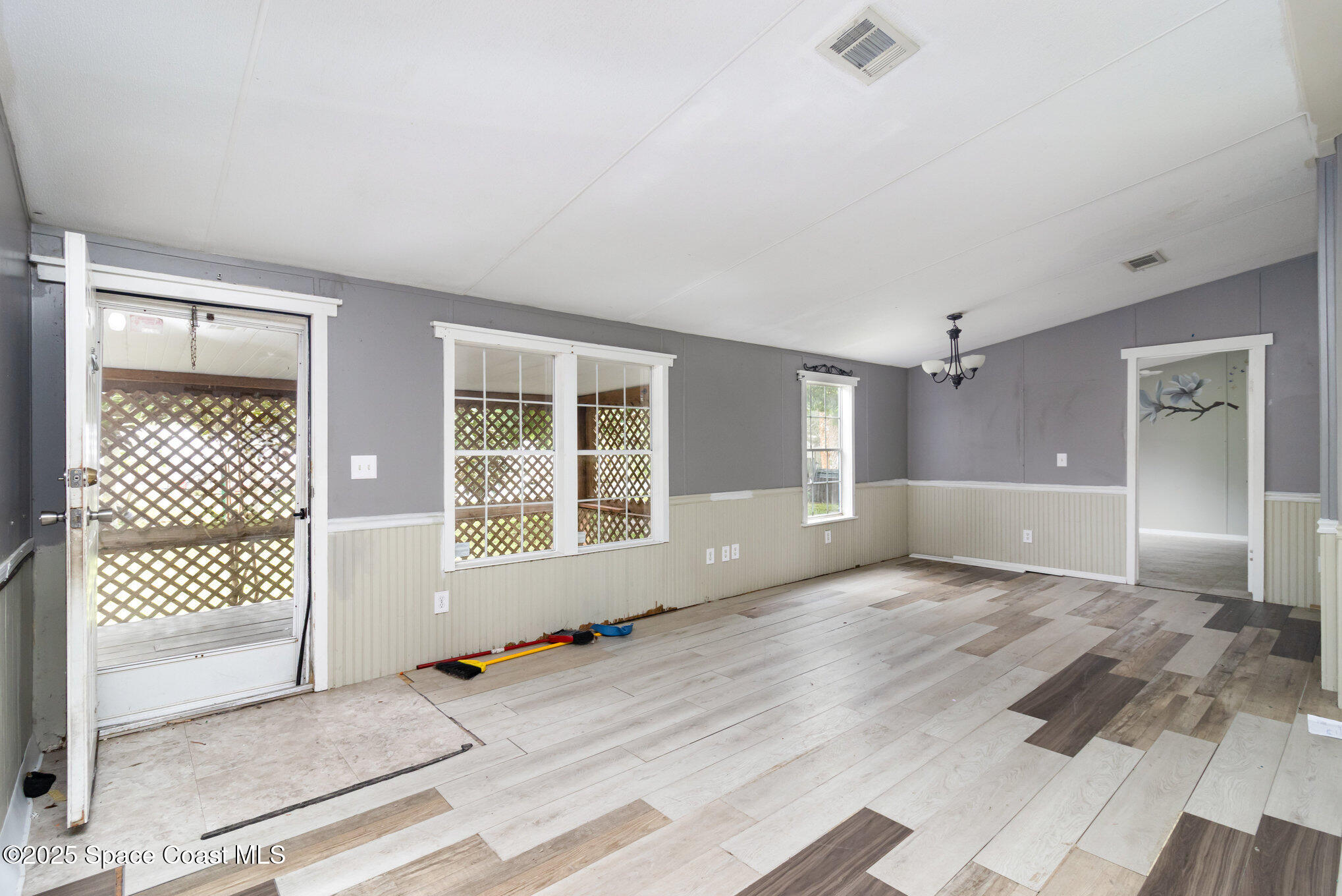 344 Robyn Street Cocoa, FL 32927 - Photo 2 of 21 en empty room with wooden floor and windows