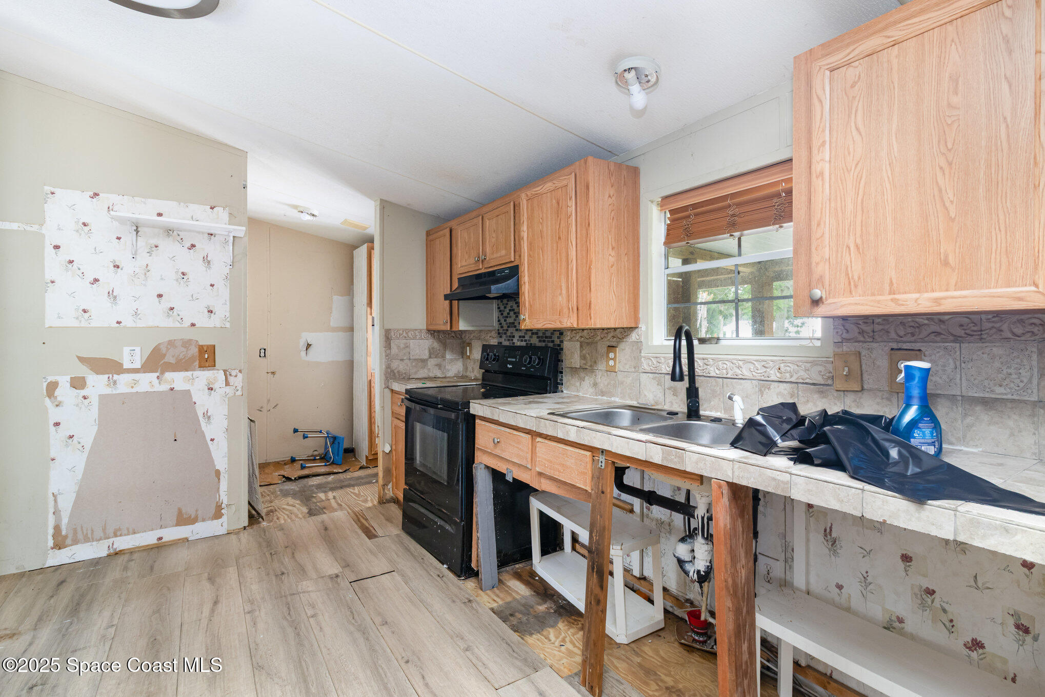 344 Robyn Street Cocoa, FL 32927 - Photo 4 of 21 a kitchen with a sink a stove a refrigerator and a window