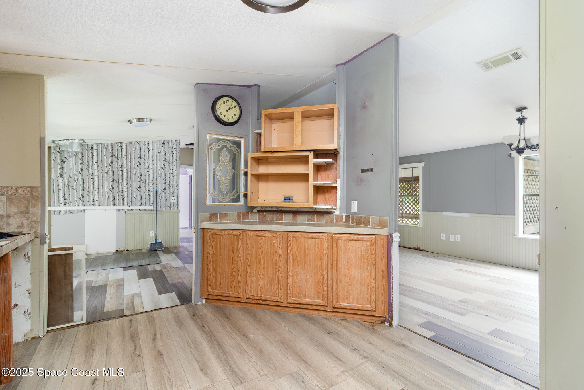 344 Robyn Street Cocoa, FL 32927 - Photo 5 of 21 a view of a kitchen with wooden floor and cabinets